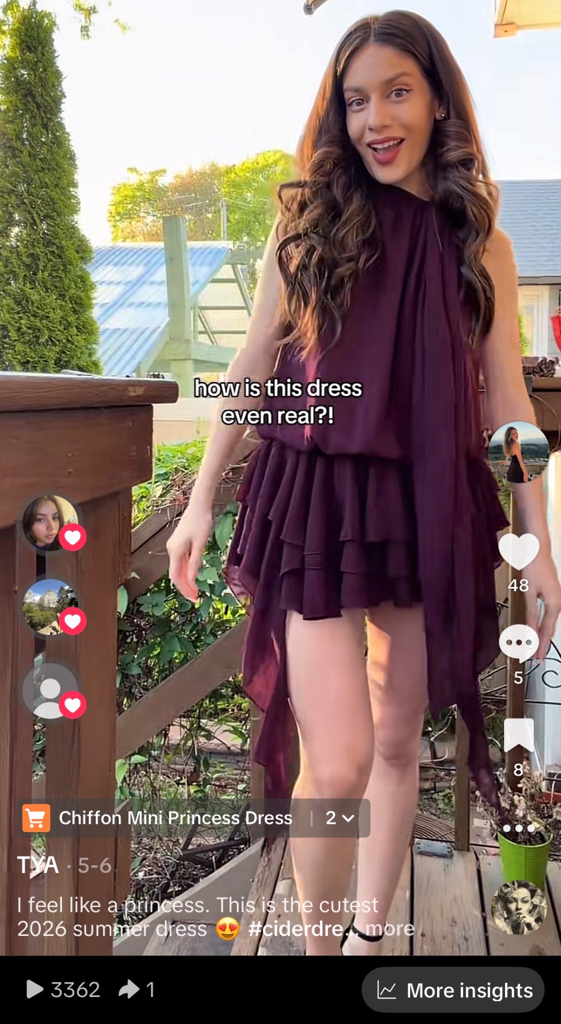 Tya wearing a deep purple ruffled chiffon mini dress on a wooden deck